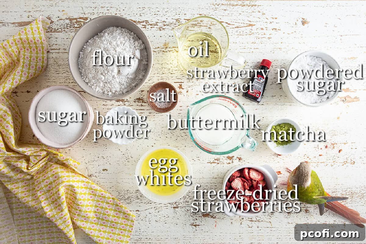 Various ingredients for a strawberry matcha loaf, including flours, sugars, and flavorings, neatly arranged in separate bowls on a rustic wooden background.