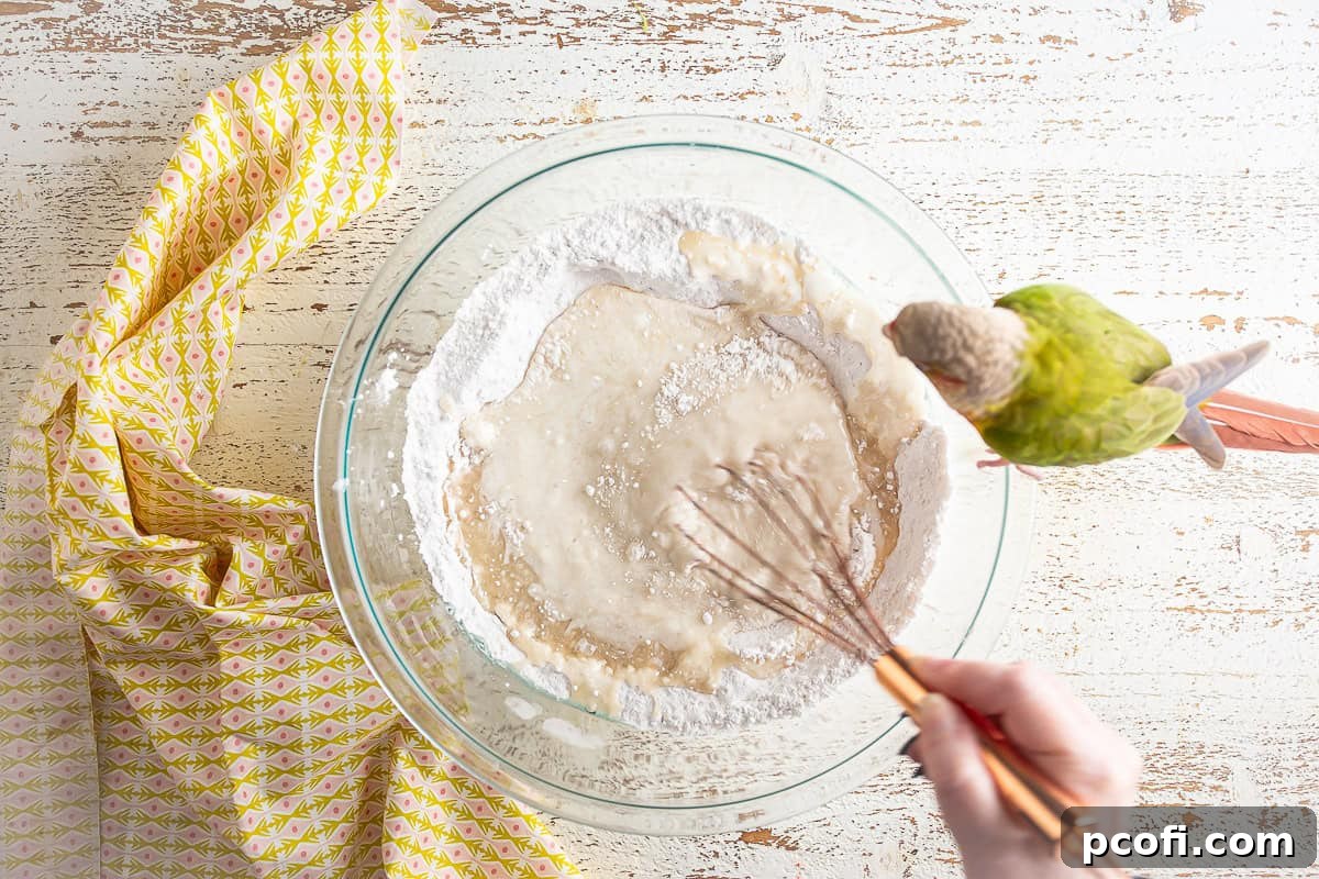 The strawberry matcha loaf batter being smoothly whisked until fully combined.