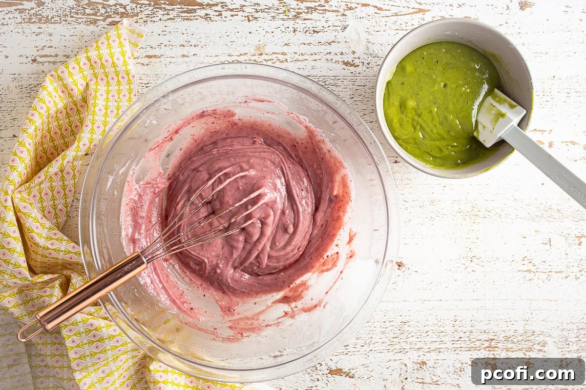 Two bowls of batter, one pink strawberry and one green matcha, prepared for layering.