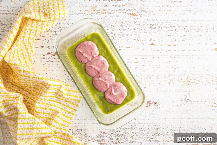 First layer of green matcha batter spread evenly in a loaf pan.