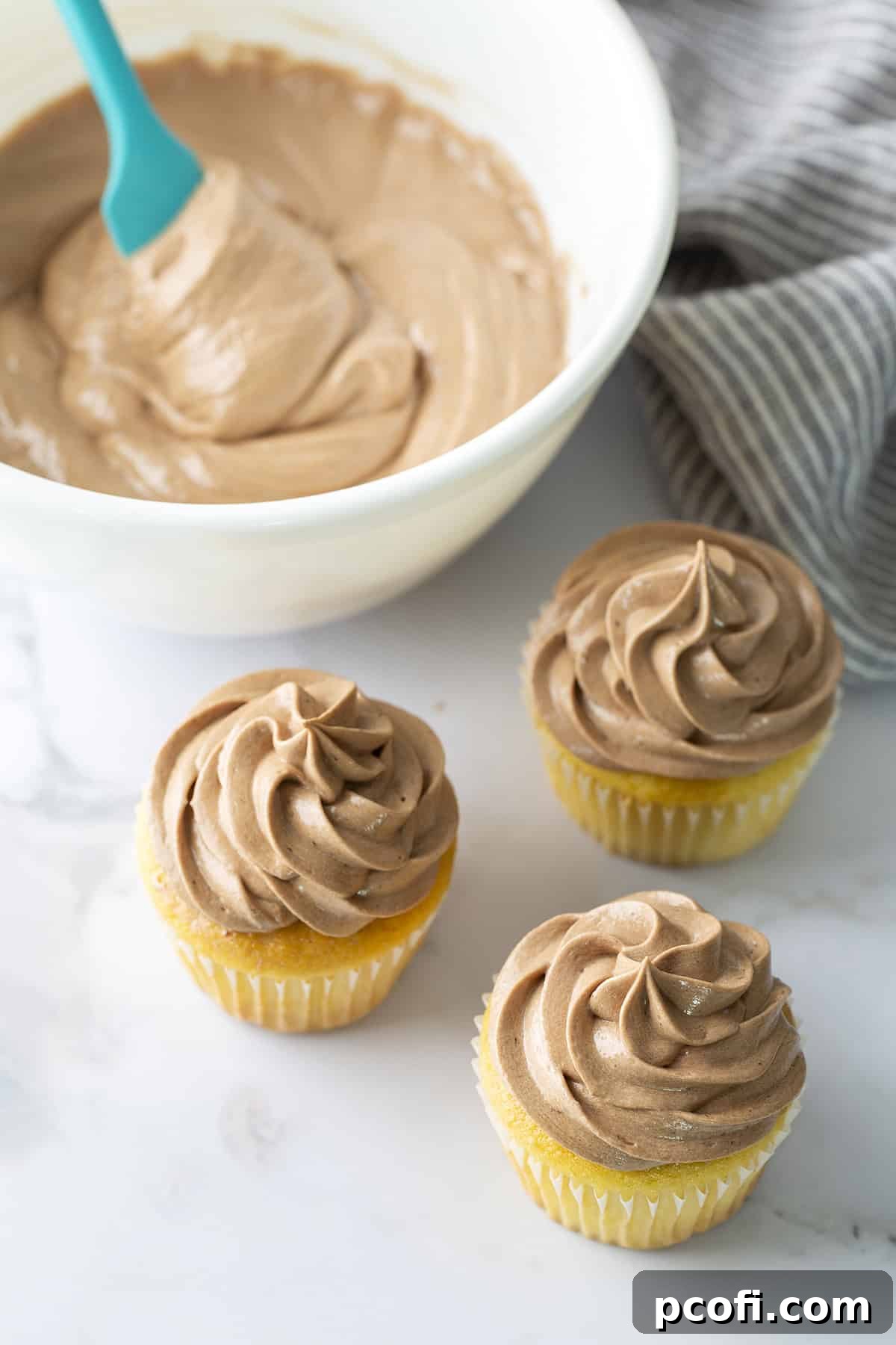 Cupcakes topped with a swirl of chocolate ermine frosting.