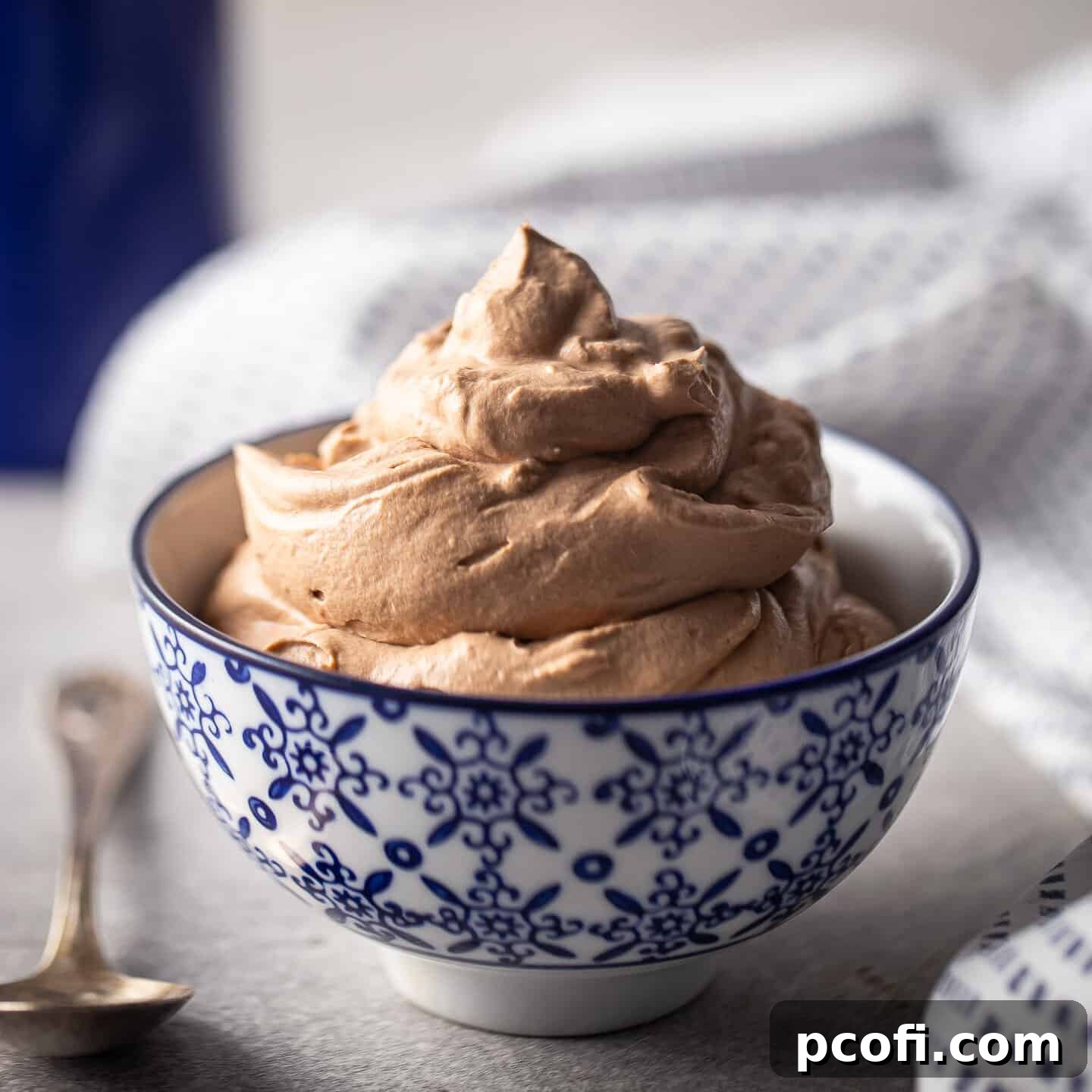 Chocolate whipped cream piled into a blue and white bowl.