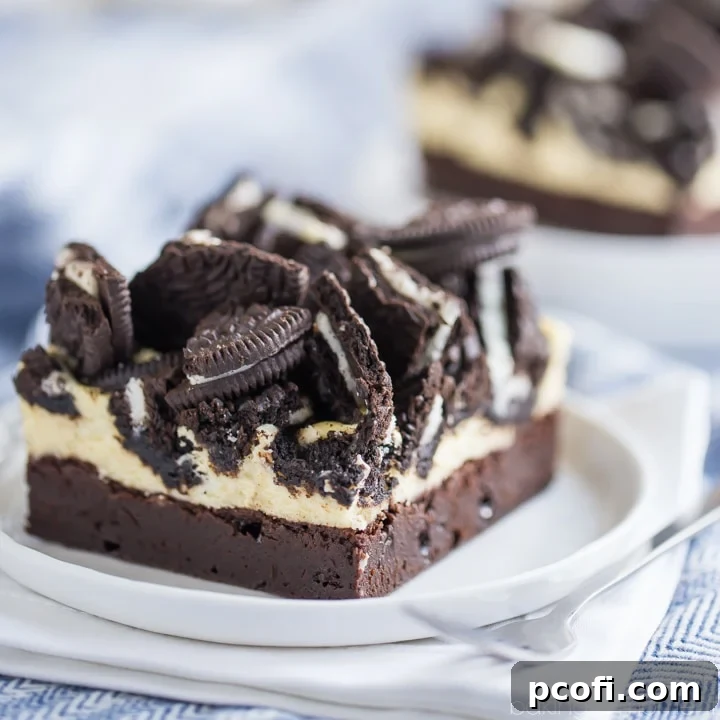 Oreo Cheesecake Brownie Bars, layered with creamy vanilla cheesecake and crunchy Oreo bits.