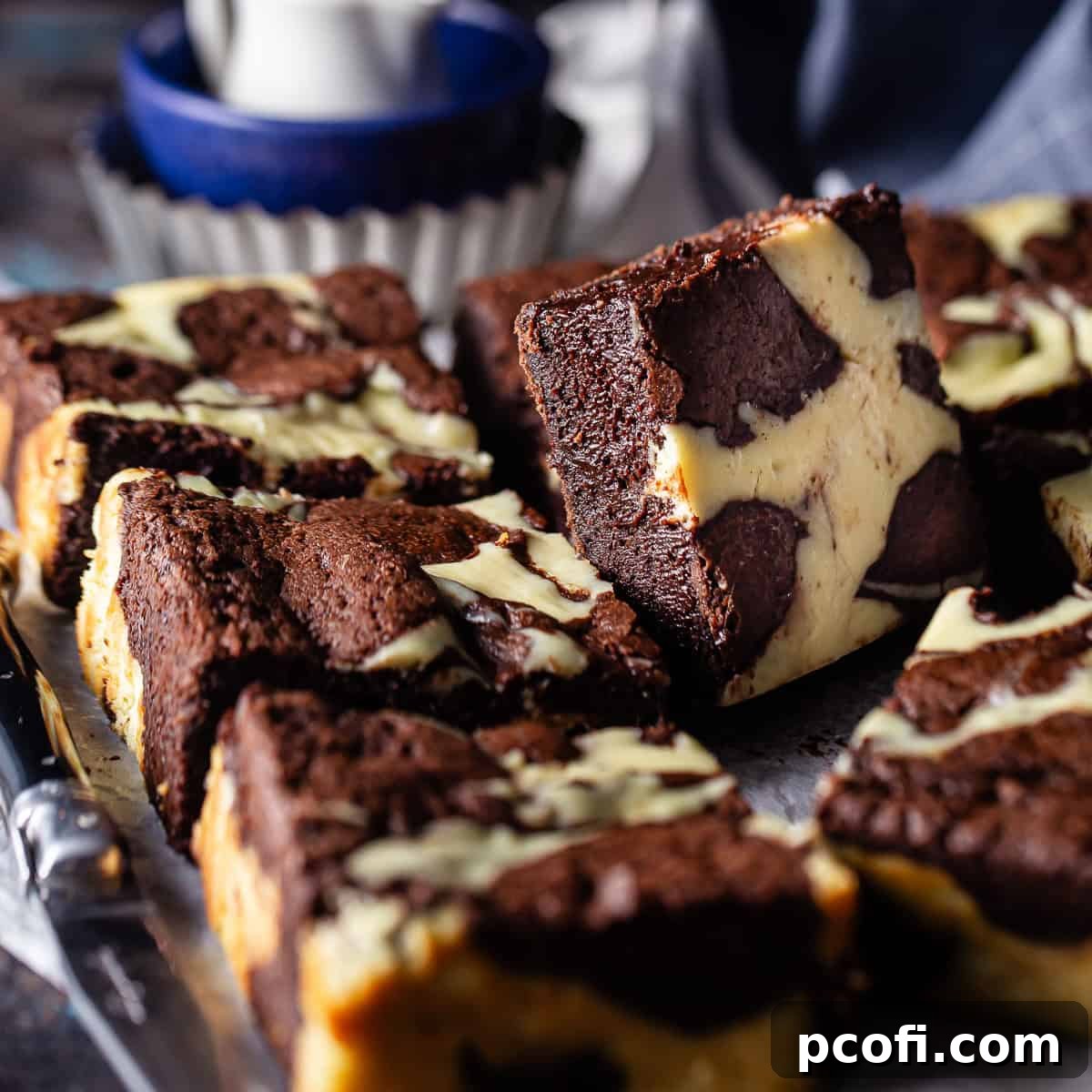 Marbled Cheesecake Brownies featuring swirls of rich chocolate and tangy cream cheese.