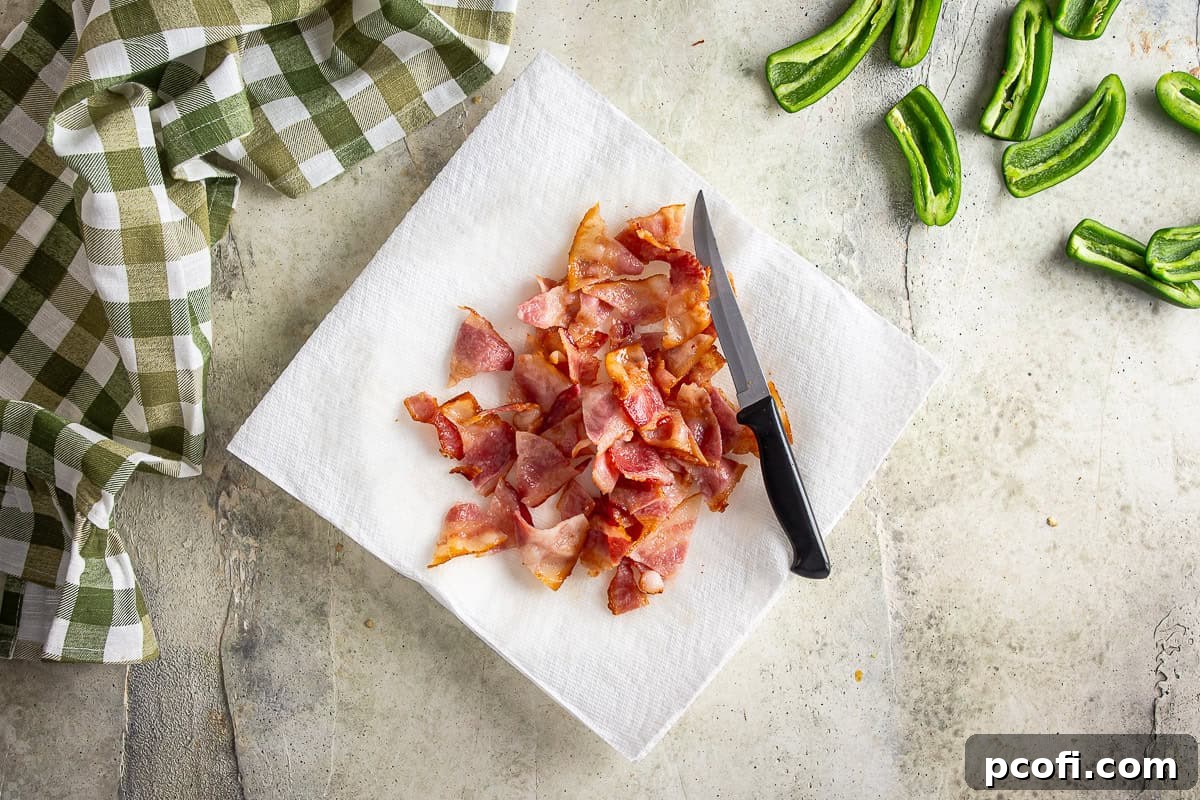 Partially cooked bacon after being cut into bite-sized pieces.