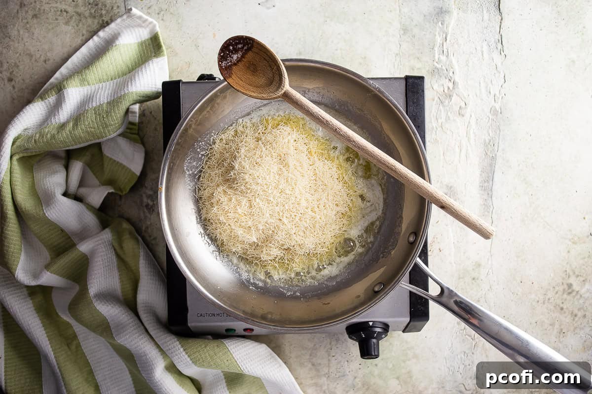 Butter melting in a large skillet, with kataifi about to be added for toasting, a crucial first step in making Dubai chocolate.