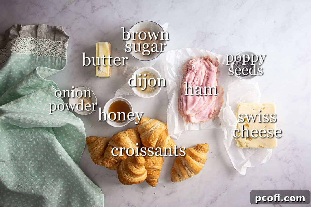 All the necessary ingredients for hot ham and cheese croissant sandwiches, neatly arranged in separate bowls and containers on a rustic surface.
