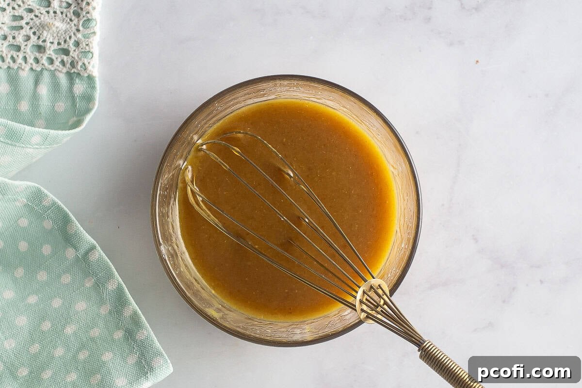 The smoothly whisked mixture of butter, brown sugar, Dijon mustard, honey, and onion powder, ready for glazing.