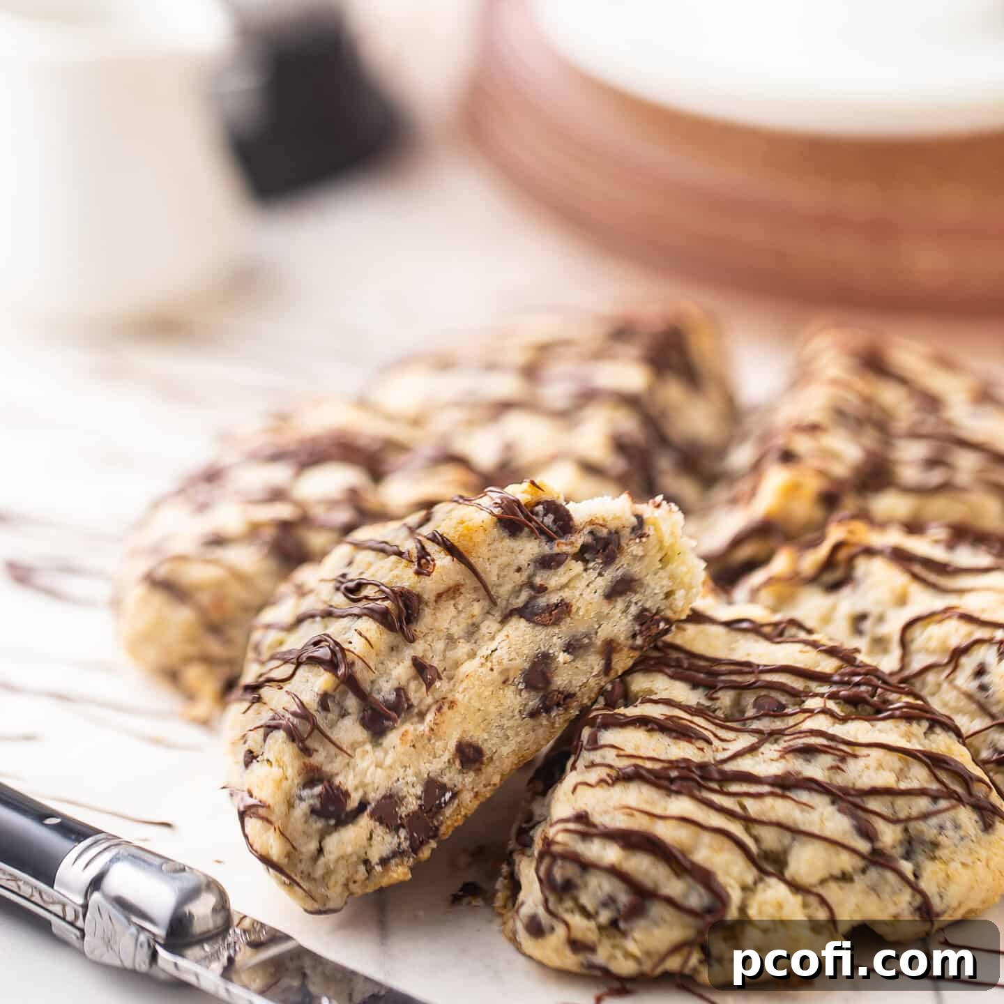 Fluffy chocolate chip scones drizzled with melted chocolate.
