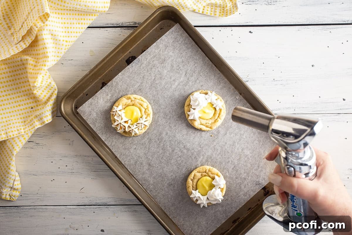 Torching the meringue on the lemon meringue pie cookies.