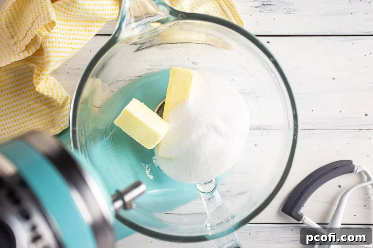 Adding butter and sugar to a mixing bow.