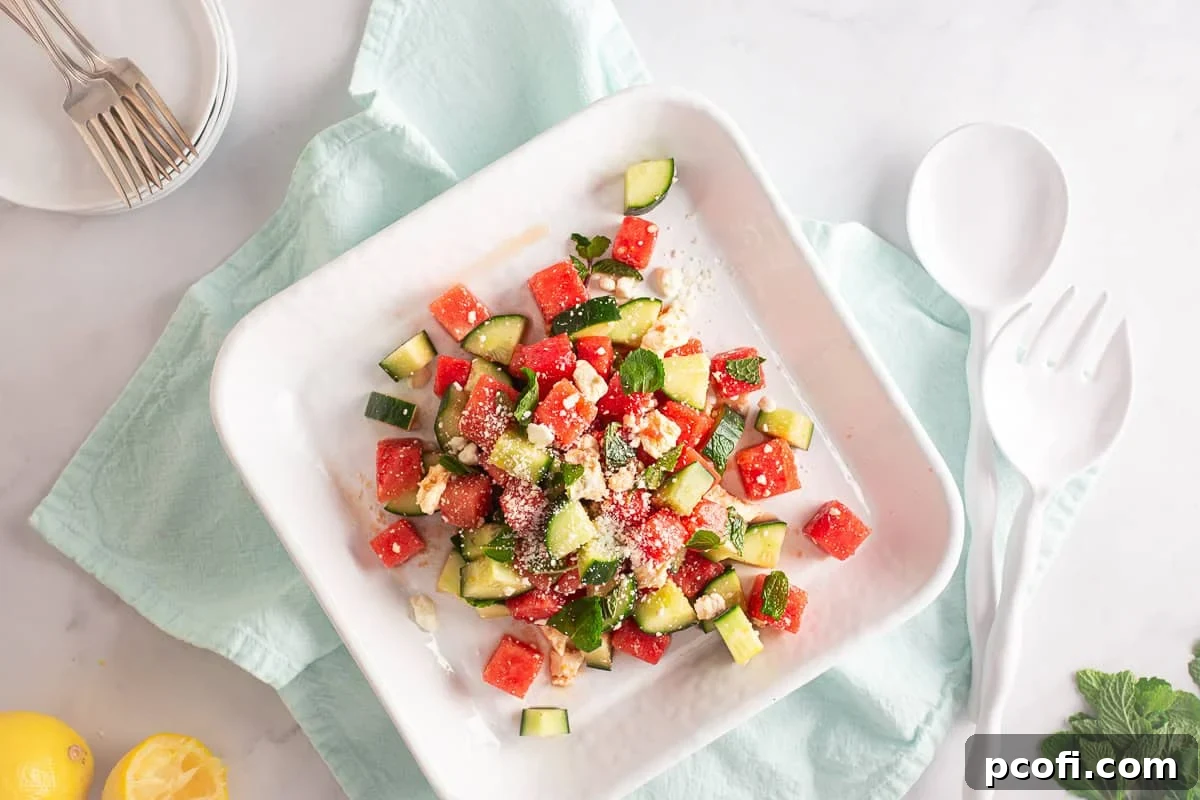 Refreshing Watermelon, Feta & Mint Salad Recipe 7 Watermelon salad after being tossed and plated on a white plate.
