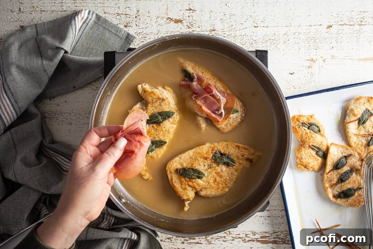 Adding prosciutto to the chicken breasts in the sauce. 