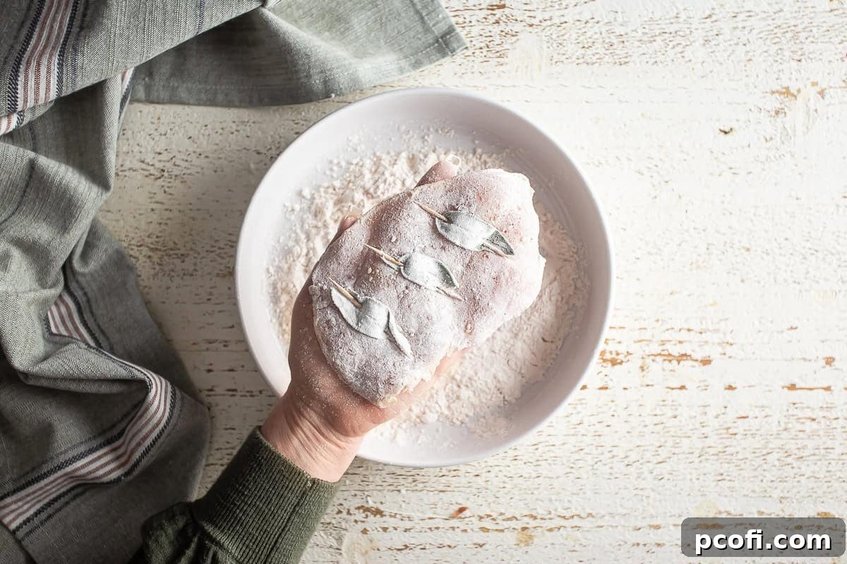 Both sides of a chicken breast for saltimbocca coated in flour.