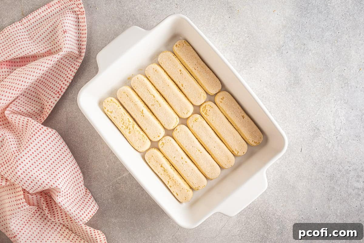 Strawberry Tiramisu Recipe with Mascarpone and Ladyfingers 12 Ladyfingers in the bottom of a dish.