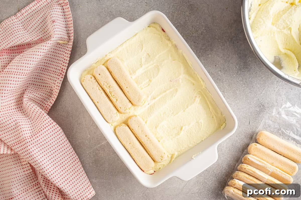 Strawberry Tiramisu Recipe with Mascarpone and Ladyfingers 15 Layering ladyfingers onto the strawberry tiramisu.