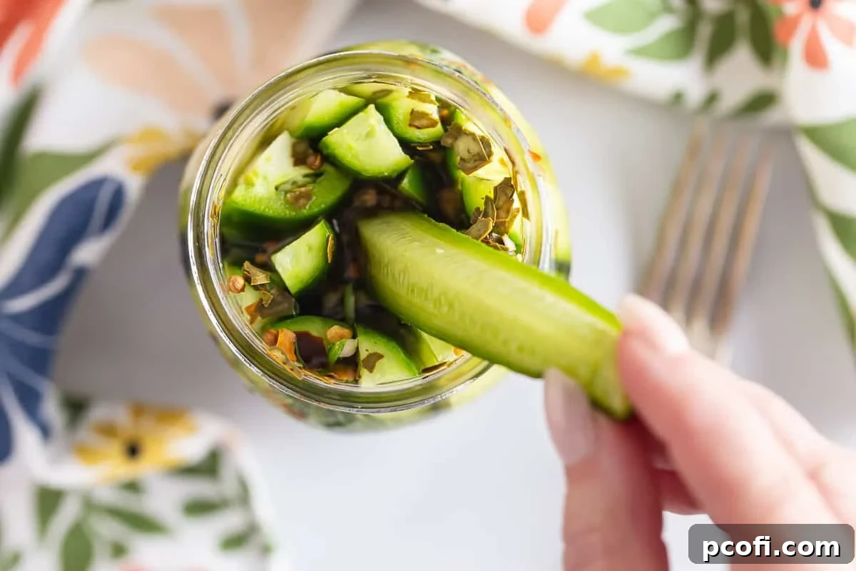 Homemade Dill Pickles: Crispy Refrigerator and Canning Recipes 9 Dill pickle spears in a jar in an overhead view.